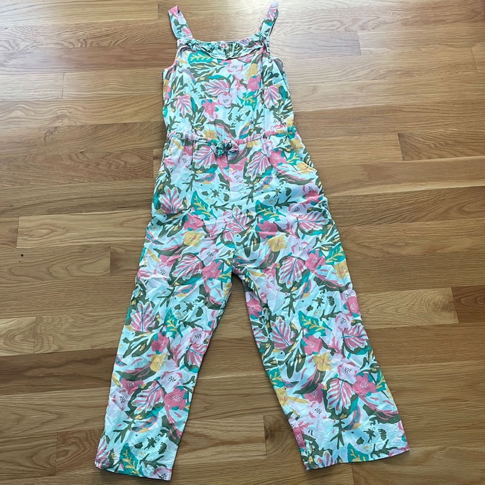 white romper/jumper with pink and green flowers and leaves.